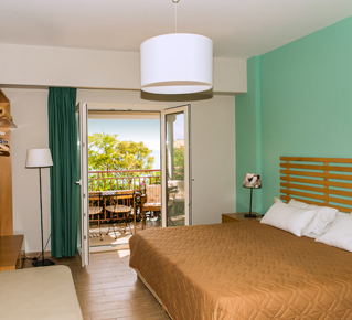Studio at Lemonia Accommodations with double and single bed and terrace with garden view.