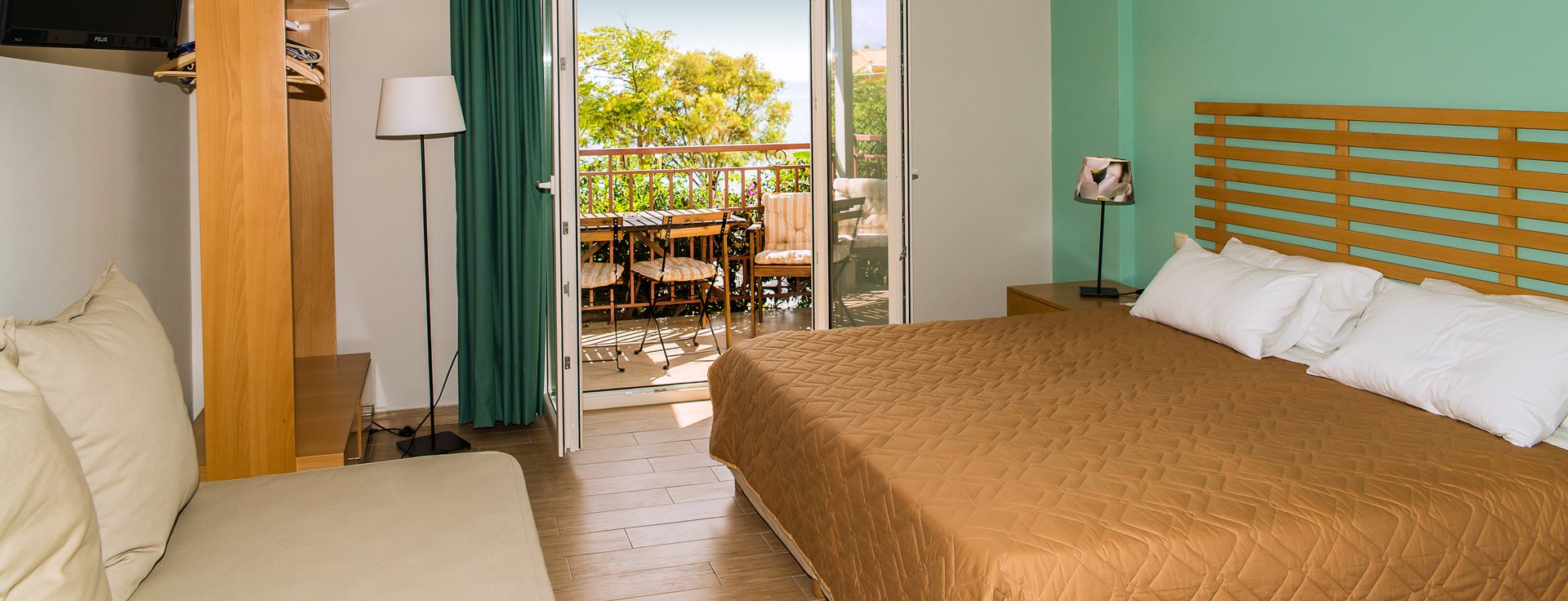 Studio at Lemonia Accommodations with double bed and terrace with garden view.